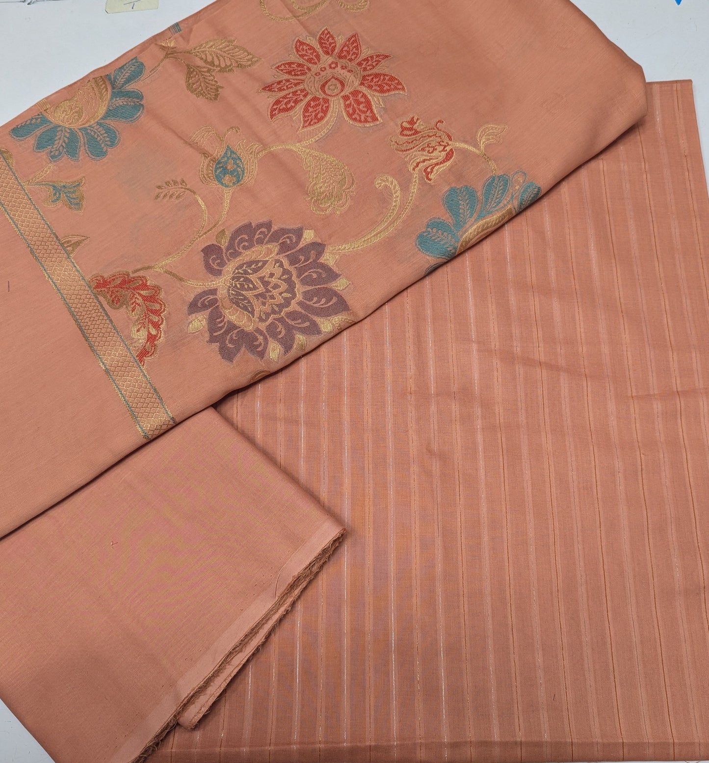 Peach-colored moon light lawn 3-piece set with premium multi-jaquard Banarasi dupatta by Hayadar Clothing, featuring intricate fabric details.