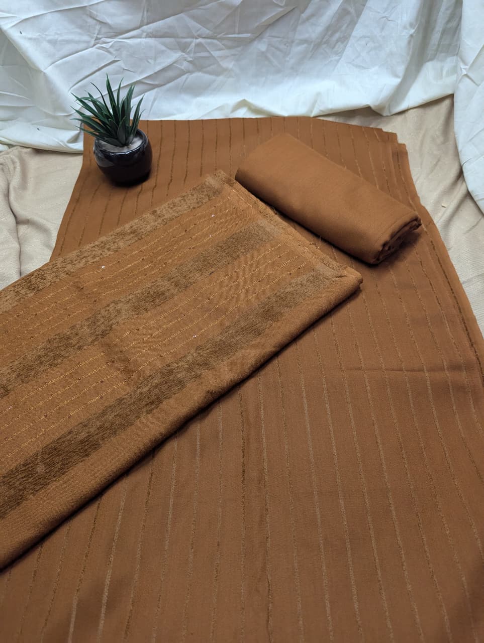 Rust-colored Hayadar Clothing 3-piece Alpine Velvet Marina set with vertical line design, showcasing luxurious fabric and stylish details.