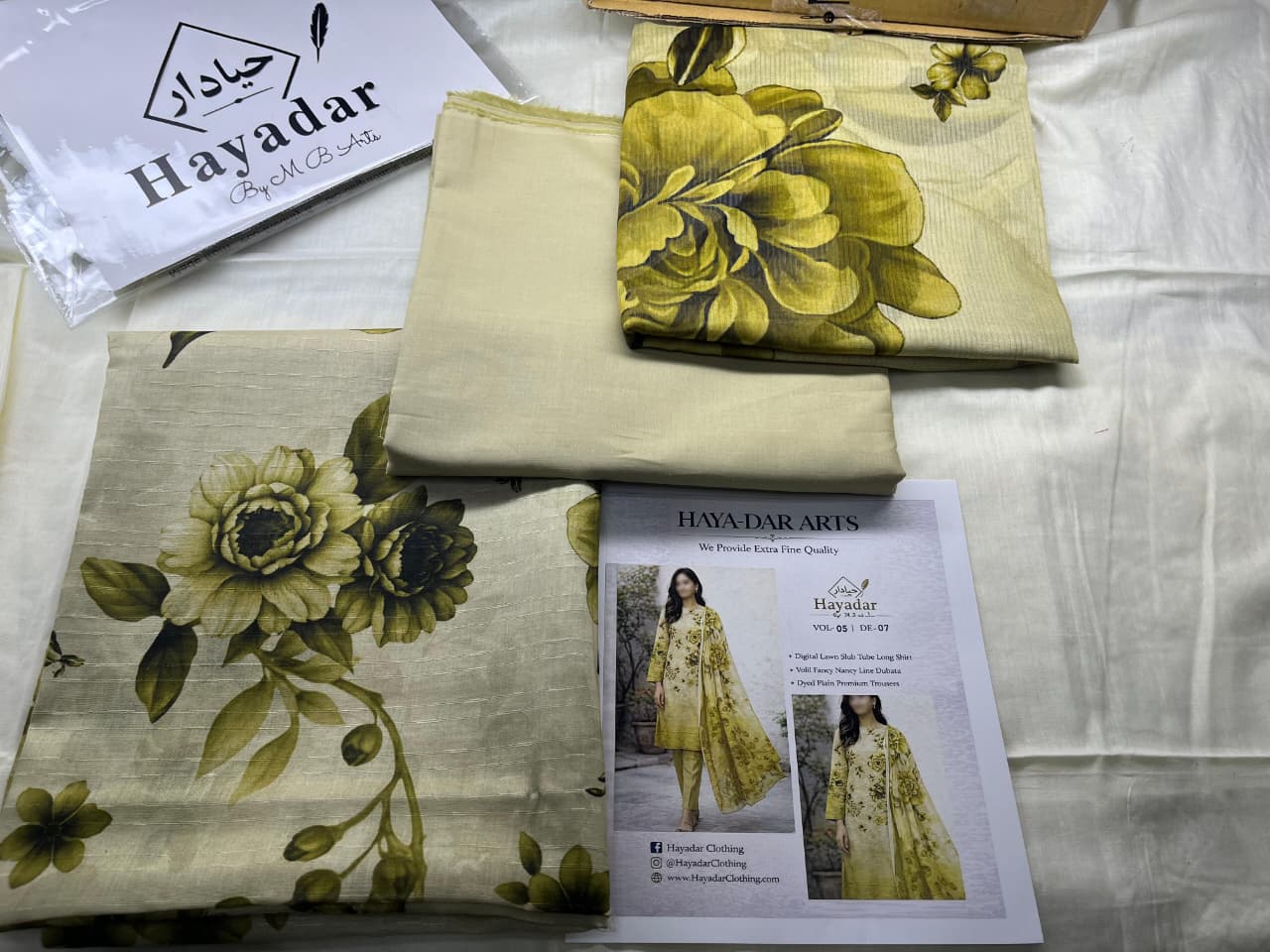 Lemon gold 3-piece premium lawn set by Hayadar Clothing featuring rice slub fabric and a voile dupatta, perfect for elegant summer wear.