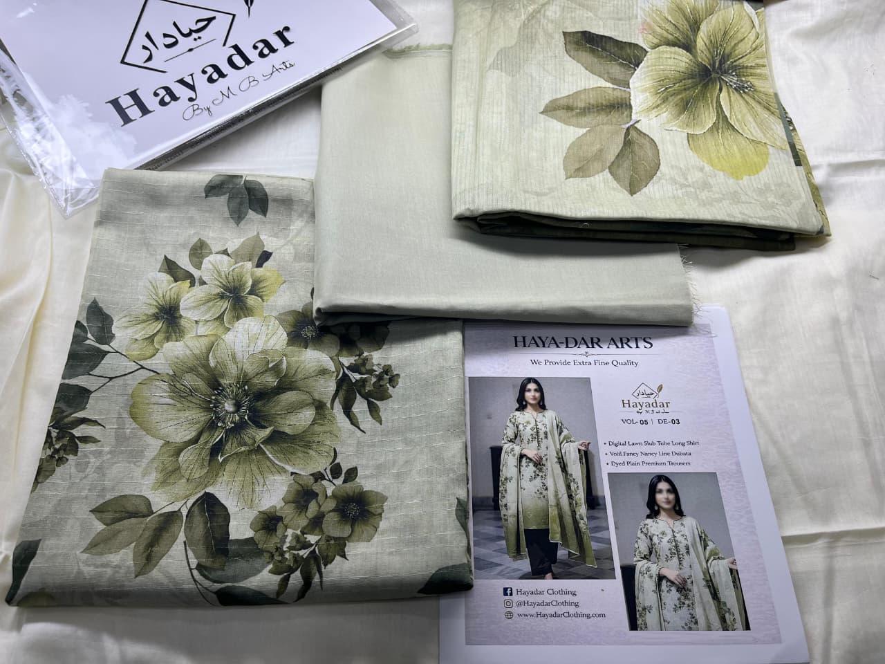 Three-piece premium lawn set with rice slub fabric and voil dupatta in soft olive grey, designed by Hayadar Clothing.